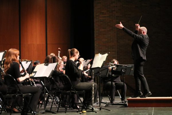 Mr. Adam Gohr, director of bands, conducts the piece “Ghosts of the Old Year by James David. The song used its harmonies and musical phrases to tell the story of David’s unease about the state of the world. 