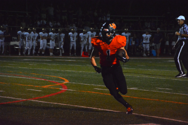 Senior Sam Seth (1) runs the ball down the field, leaving Lemont's defense in his trail.