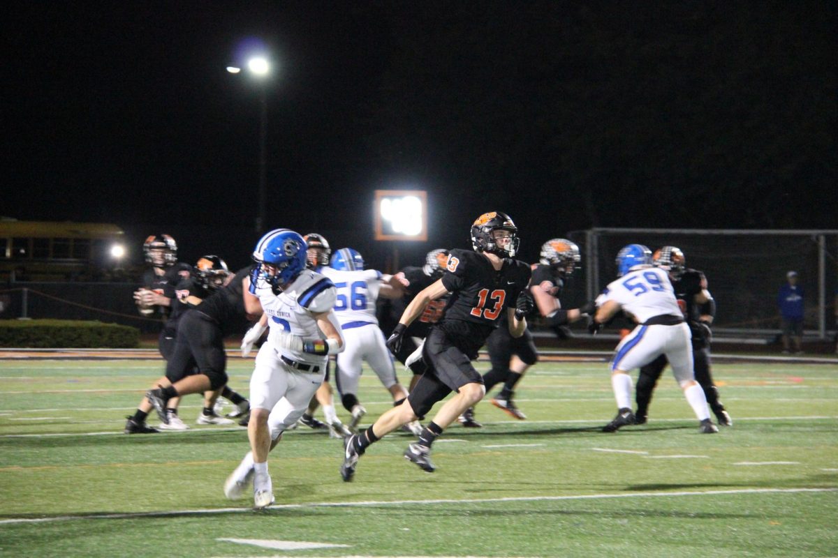 Sophomore Brock Williams (13) runs down the field to assist his team offensively. Williams is one of three underclassmen on the team.