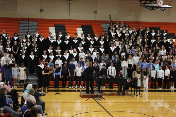 On Wednesday, October 30th the combined LHS and middle school choirs sing the songs “Stand Together” by Jim Papoulis and “Crowded Table” by the Highwomen arr. Ramsey. Retired from Stevenson High School, Mrs. Alice Nuteson was the guest conductor for the combined choir  Sophomore violinist Dani Hwang plays the accompaniment with pianist Mrs. Claire Dixon.