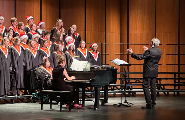 Dr. Brown conducts the LHS Concert Choir, leading them in “The Holiday Season” by Andy Williams. Dr. Brown has been teaching at Libertyville High School since 2001 and works to enhance the choir experience for his students. “Please come and be in choir,” said Dr. Brown. “If you're reading this, it's a fun place to be, and it's singing is not something that is so scary. I enjoy music and want to be around people who enjoy singing and having fun.”