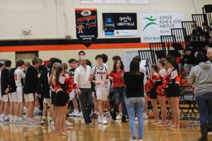 Senior Liam Hanson (1) is escorted by his parents before the game to celebrate senior night. He will miss “hanging out with [his] boys and going out to eat after games and practices.” 